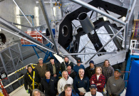 The Keck summit crew showing off the mirror of the Keck telescope on the summit of Mauna Kea. - Photo Credit: Rick Peterson