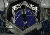 A shot of the primary mirror of the Keck II telescope. For scale, note the railings around the large steel platform. - Photo Credit: Andrew Cooper